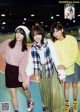 A group of young women standing next to each other on roller skates.