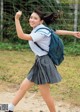 A young woman in a school uniform with a backpack.